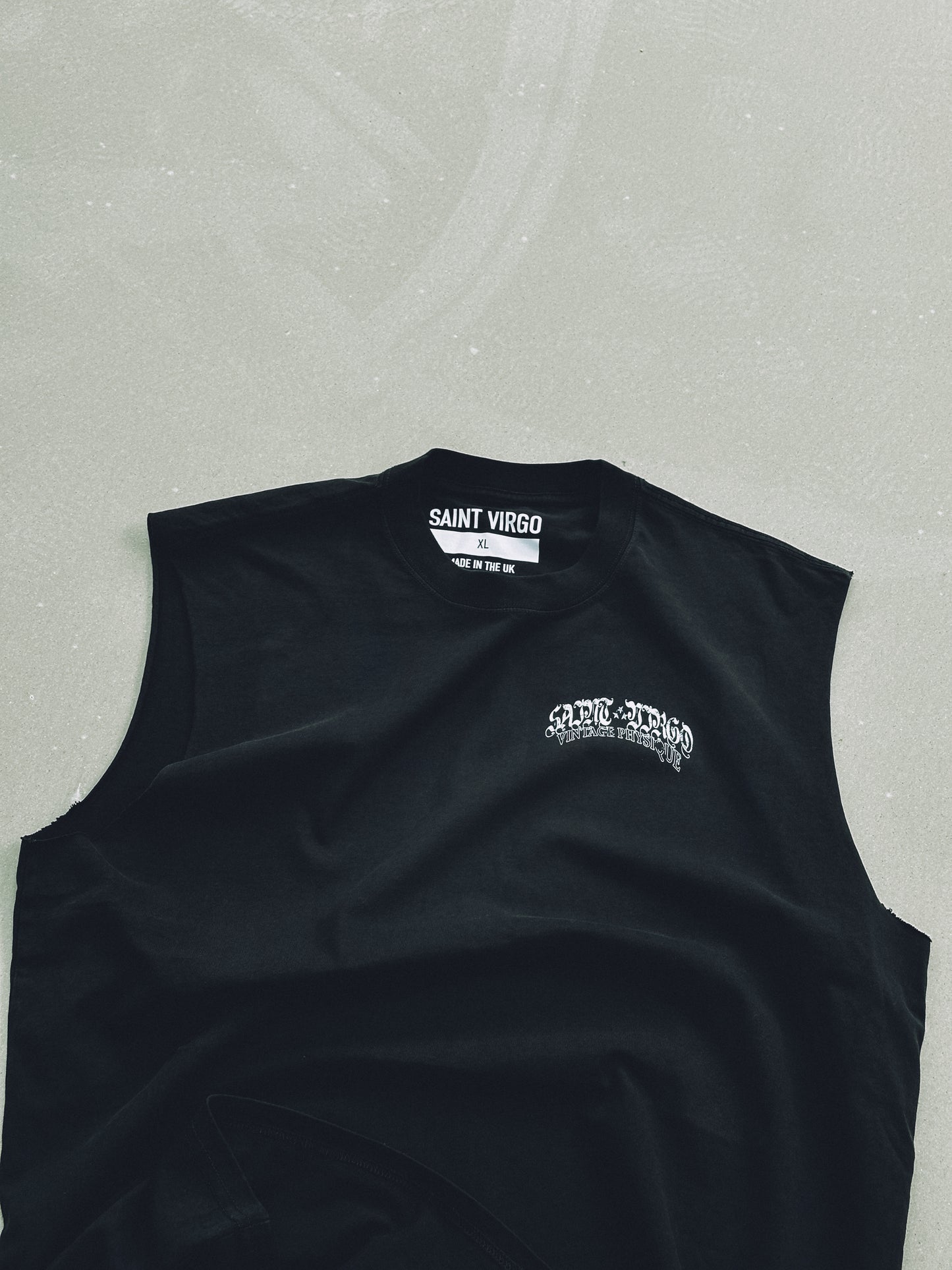 Saint Virgo Vintage Physique Cut Off Tank, blending nostalgic design with modern luxury sportswear. Crafted for those who embrace athletic essentialism, redefining sportswear with a vintage-inspired look for active lifestyles.